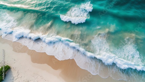 aerial top view of beautiful tropical white sand beach with wave foam and sea summer vacation and travel background with copy space top view from drone