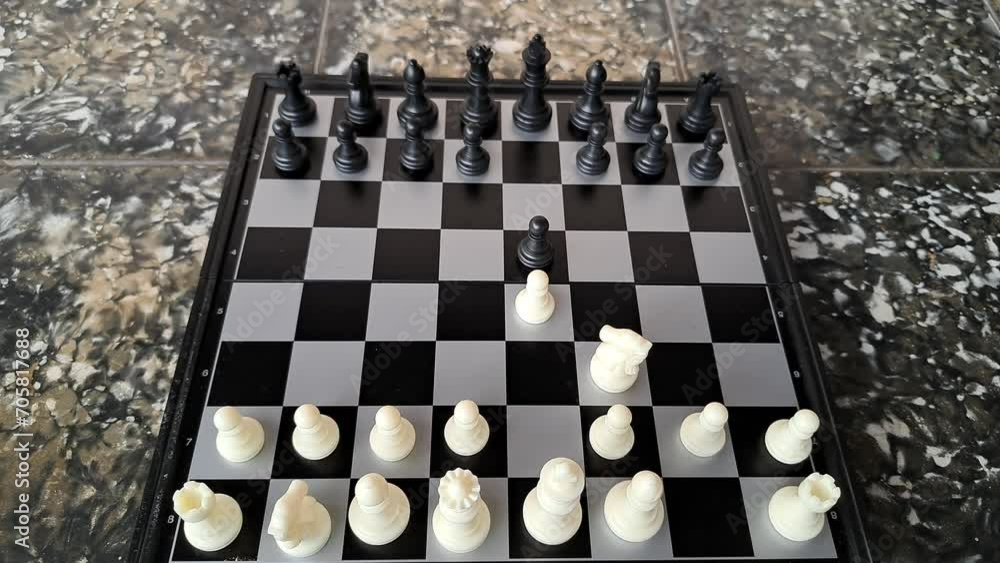 Video of a man's hand demonstrating a chess opening move. Video of a man's hand demonstrating a chess opening move.