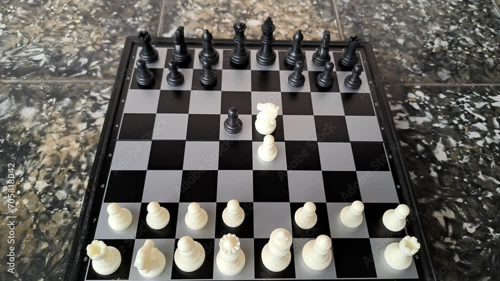 Video of a man's hand demonstrating a chess opening move. Video of a man's hand demonstrating a chess opening move.