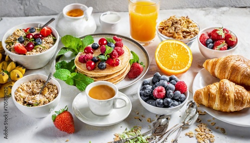 healthy breakfast eating concept various morning food pancakes waffles croissant oatmeal sandwich and granola with yogurt fruit berries coffee tea orange juice white background