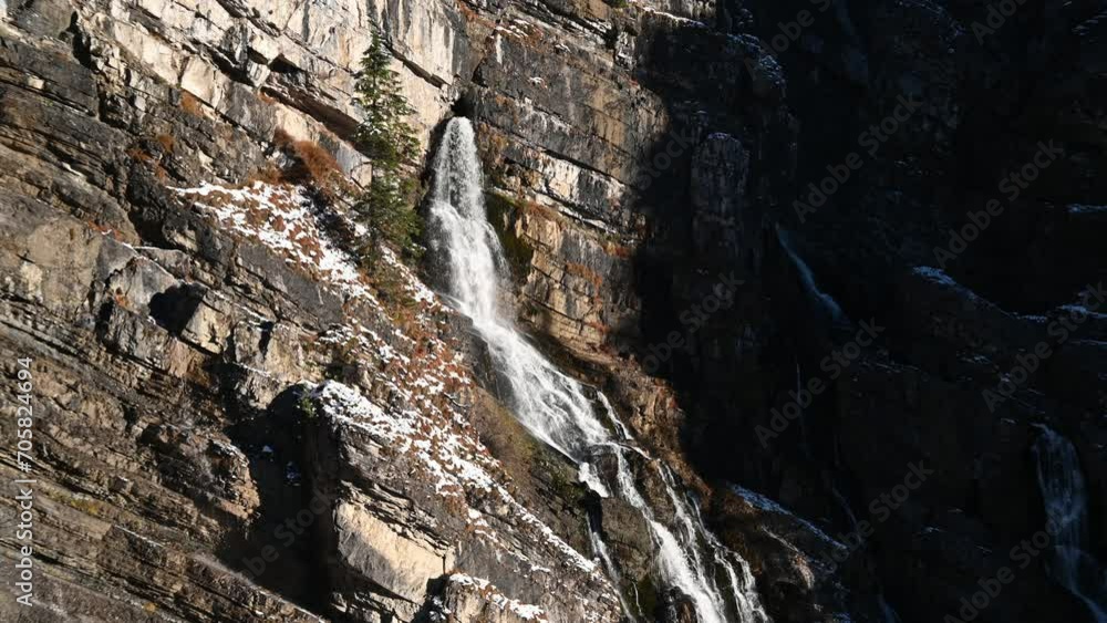 Karst springs with water flowing out of the mountain with bits of snow Karst springs with water flowing out of the mountain with bits of snow