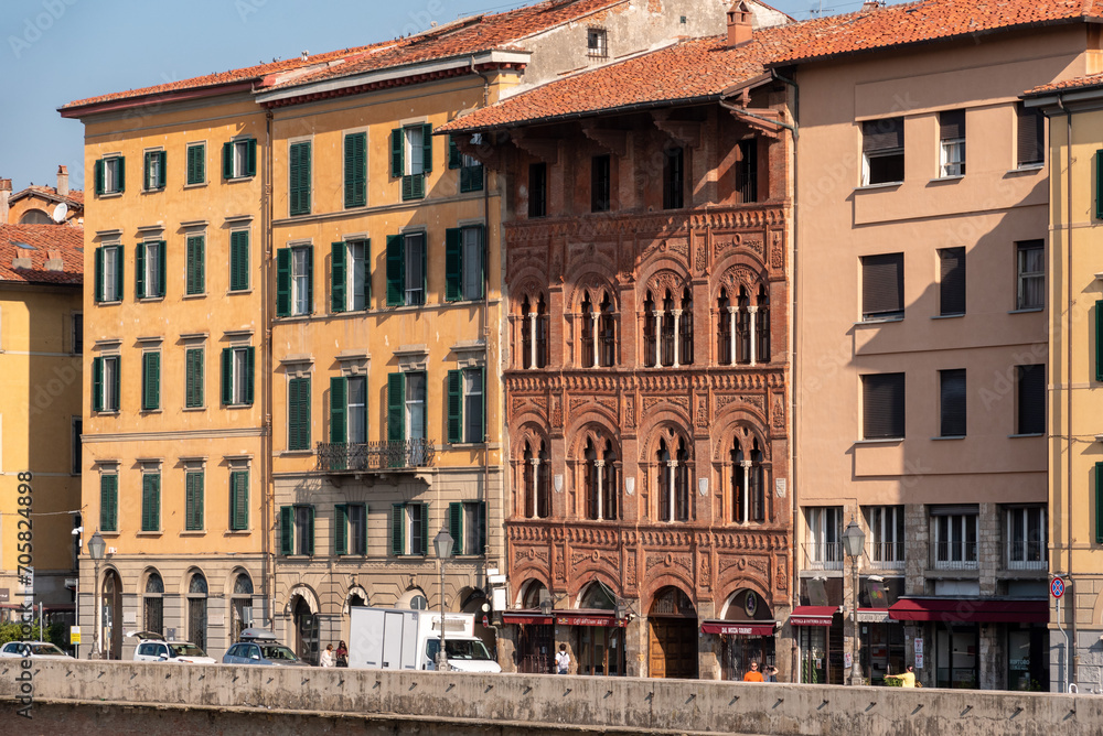 Old picturesque houses at the Arno river waterfront in Pisa