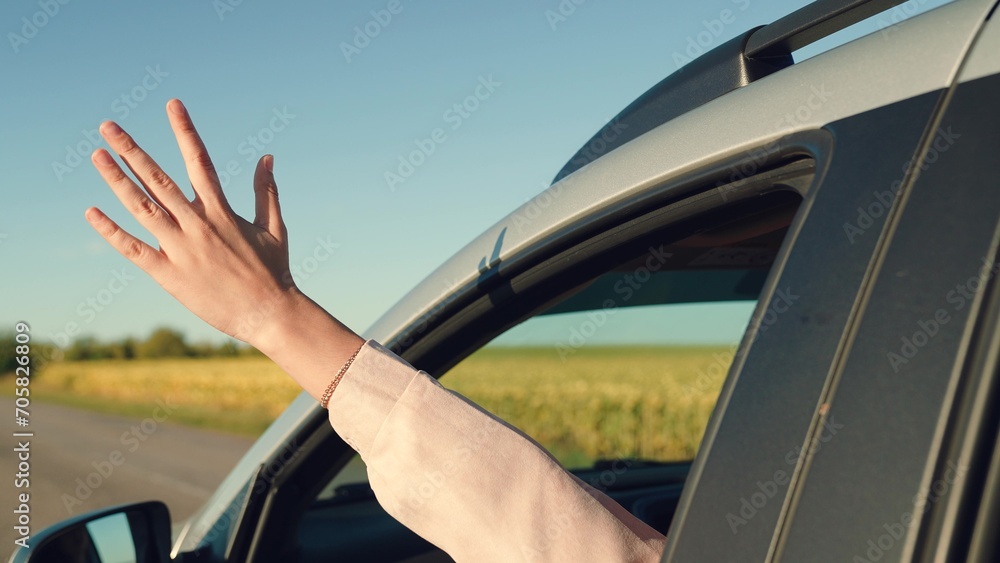 girl rides car with her hand out window, car ride, happy child traveling, traveling with friends sunny day, woman with hair enjoying trip, summer trip by car, cheerful girl looking out open car window