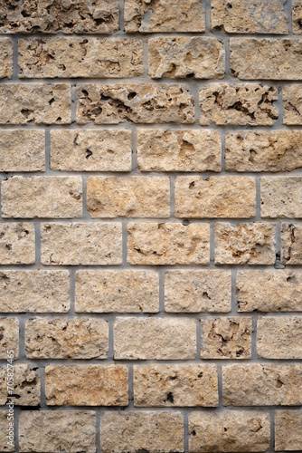 Vertical stone wall texture, masonry wall texture background, fragment of a shell wall