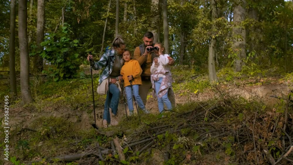 Smiling family of four enjoying hiking in trough forest. Smiling family of four enjoying hiking in trough forest.