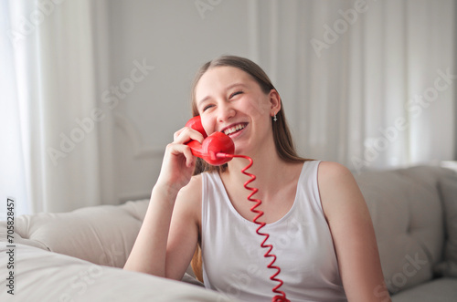 young girl speaks laughing on the phone