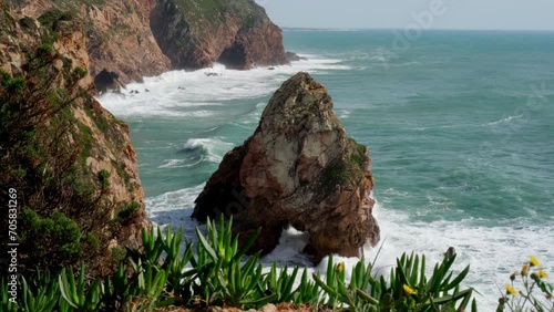 Picturesque nature of rocky sea coast, waves break with foam on rocks. Tourism and travel. View from above. Recreation and entertainment. Beautiful nature. Meditation and relaxation. 4k footage.