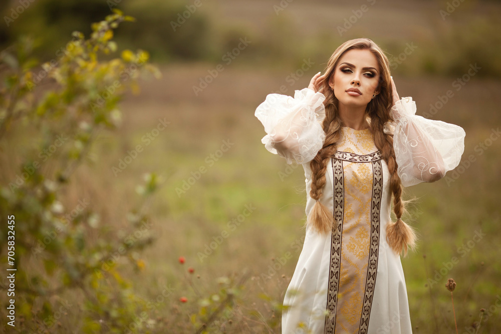 Beautiful young Russian girl with white hair in the national Russian style.hairstyle two braids Beautiful young Russian girl with white hair in the national Russian style.hairstyle two braids