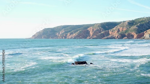 Sea tide. Waves are slowly rolling towards rocky shore. Tourism and travel. Recreation and entertainment. Beautiful nature. Picturesque views. Sea and rocks. Meditation and relaxation. 4k footage.