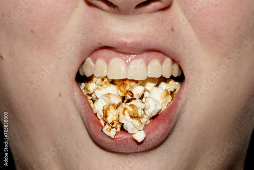 woman eating popcorn photo