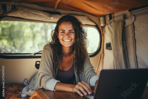 Smiling Woman Working on Laptop in a Camper Van