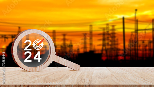 2024 year number with Target icon inside the wooden magnifying glass on industry background, business concept banner, Planning for goal and success concepts. photo