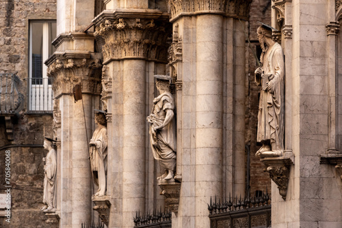 Facade of the medieval Logia della Mercanzia with statues in Siena photo
