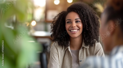 Cheerful afro-american businesswoman having a meeting with a job applicant in a creative workplace.