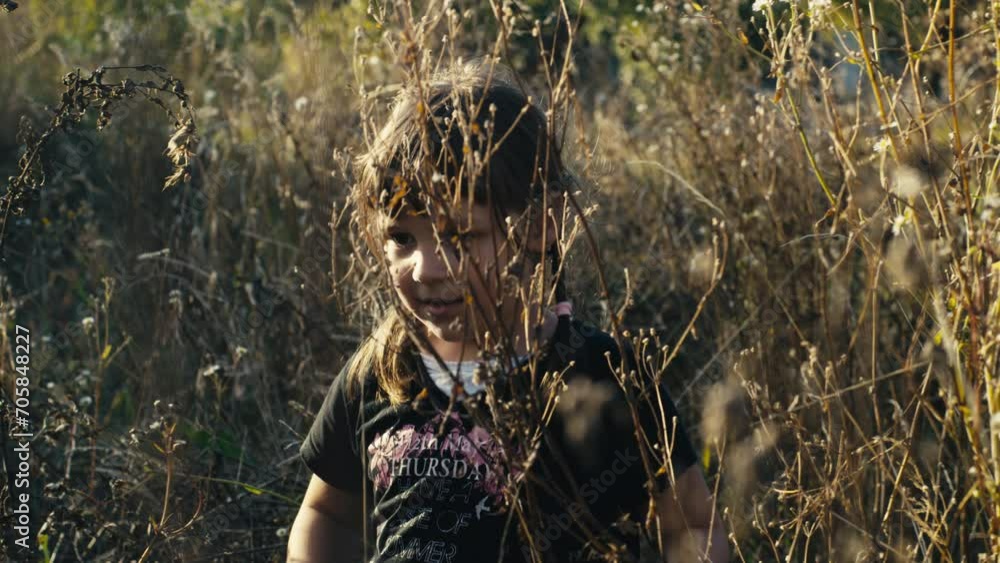 Six Year Old Caucasian Girl Cautiously Walk in the Meadow With Tall Grass Six Year Old Caucasian Girl Cautiously Walk in the Meadow With Tall Grass