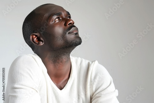 Contemplative portrait of an African man, thoughtful and introspective, white background