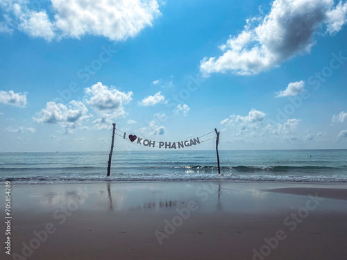 Landscape photograph of Haad Rin beach on Koh Phangan, Thailand. Sign reads I love Koh Phangan. 