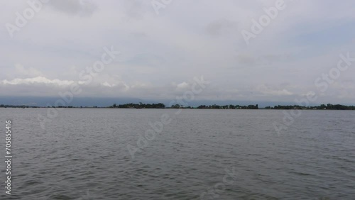 A view of the marsh water from a moving boat. Scenery of wetland water in Haor, Sunamganj, Bangladesh. photo