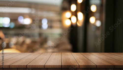  Empty wooden table top with lights bokeh on blur restaurant background. 