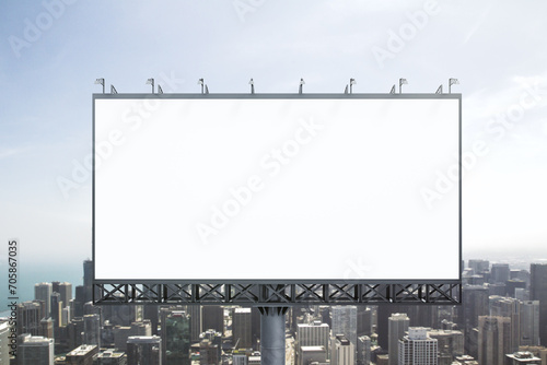 Blank white billboard on city buildings background at daytime, front view. Mockup, advertising concept
