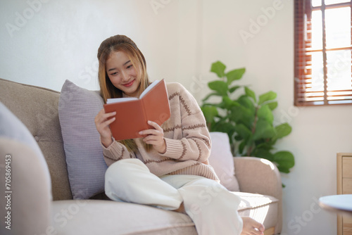 Young asian woman reading a book at home, girl hold book Education school university college concept.concept