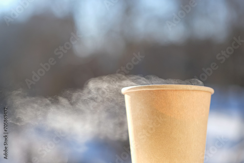 The movement of steam over the disposable paper cup. Liquid evaporation. Cold air. Mock up. Copy space.