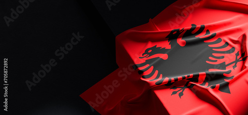 Flag of Albania. Fabric textured Albania flag isolated on dark background. 3D illustration photo
