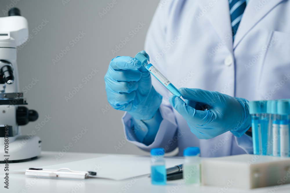Scientist wearing medical gloves nanotechnology, research, fiber, microbiology, glass, test tube, medicine, healthcare, pharmaceutical manufacturing, laboratory, science, chemistry, genetics, genes. Scientist wearing medical gloves nanotechnology, research, fiber, microbiology, glass, test tube, medicine, healthcare, pharmaceutical manufacturing, laboratory, science, chemistry, genetics, genes.
