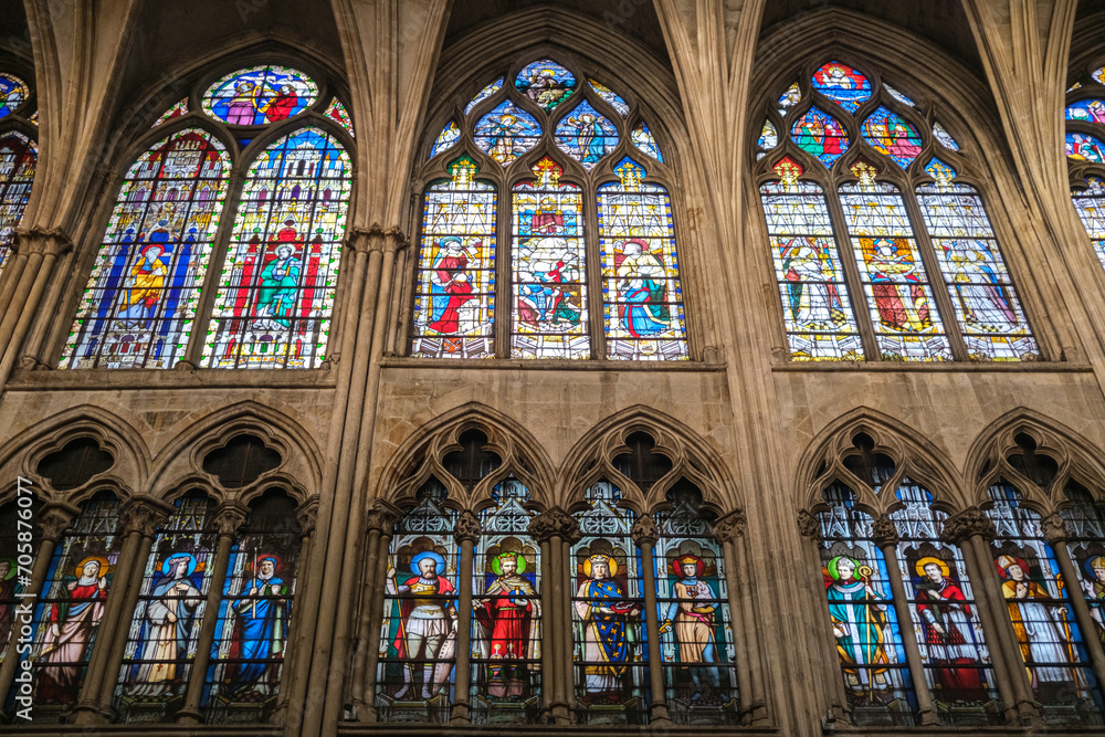 Beautiful stained glass windows with colorful biblical scenes, inside a Parisian church.