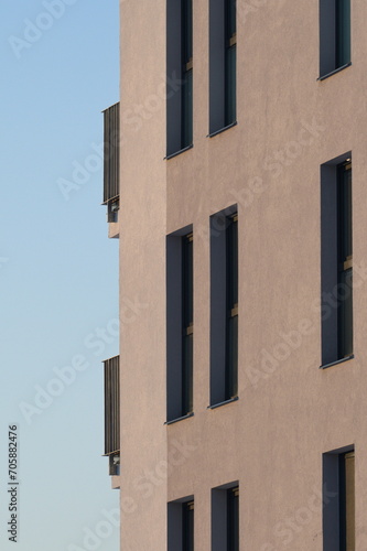 Newly built block of flats. Modern generic architecture. New home building and living concept. Housing availability concept. Blue sky background. 