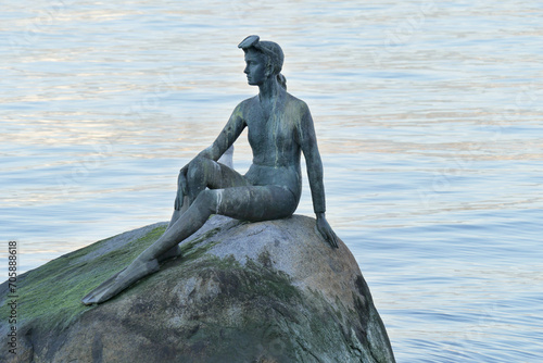 The Girl in a Wetsuit bronze sculpture between Brockton Point and the Lions Gate Bridge at Stanley Park in Vancouver, British Columbia, Canada