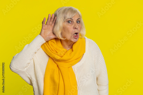 I cant hear you. What. Senior old woman trying hear you, looking confused and frowning, keeping arm near ear for louder voice, asking to repeat to hear information deafness. Elderly mature grandmother photo