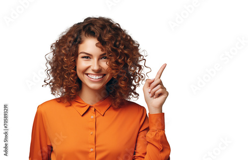 A joyful woman with curly red hair, wearing an orange shirt, happily points upwards to the best offer, discount, interesting or important product. Transparent isolated background.