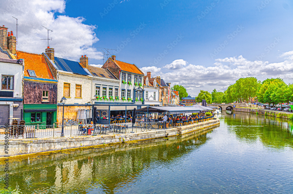 Amiens cityscape old town Saint-Leu quarter, embankment Quai Belu of Somme river water canal, street restaurants, traditional houses and bridge in historical centre, Hauts-de-France Region, France