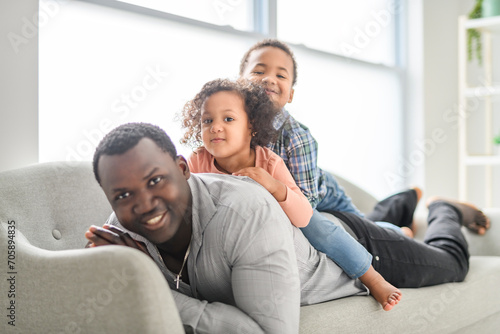 American father with little boy and girl at home
