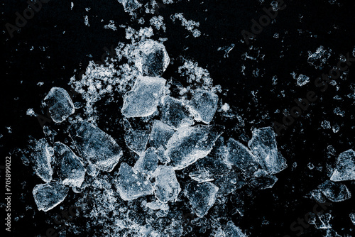 Ice cubes crush on a black background. Chill backdrop.