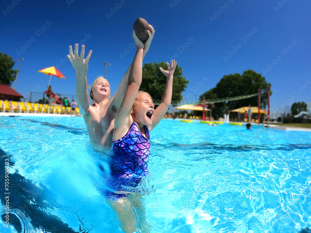 Happy Kids Playing Catch in Swimming Pool on Summer Day