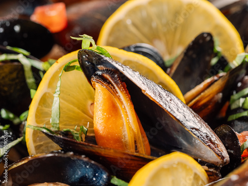 cooked mussels with lemon on white plate. Restaurant-style seafood plating. Seafood and mossels food background photo