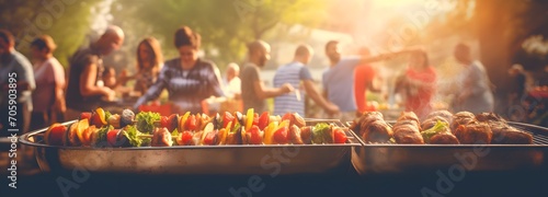 Friends gather for a barbecue outdoors in the summer