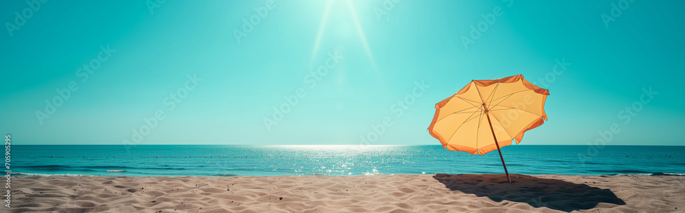 umbrella in the sand, sea in the background, strong sunlight, summer vacation concept, banner copy space