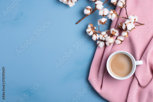 a cup of coffee and cotton flowers