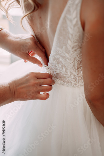 A person getting their wedding dress done. 5309