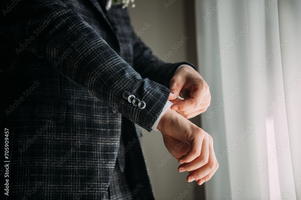 A person indoors holding a black object. 5387