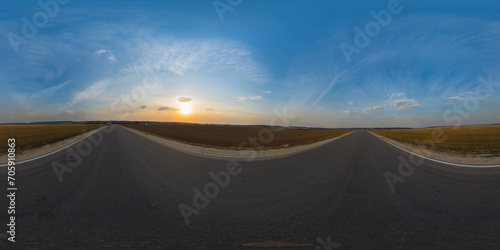 360 degree spherical panorama on country asphalt road among fields at sunset or sunrise with beautiful sky and cirrus clouds. VR content.