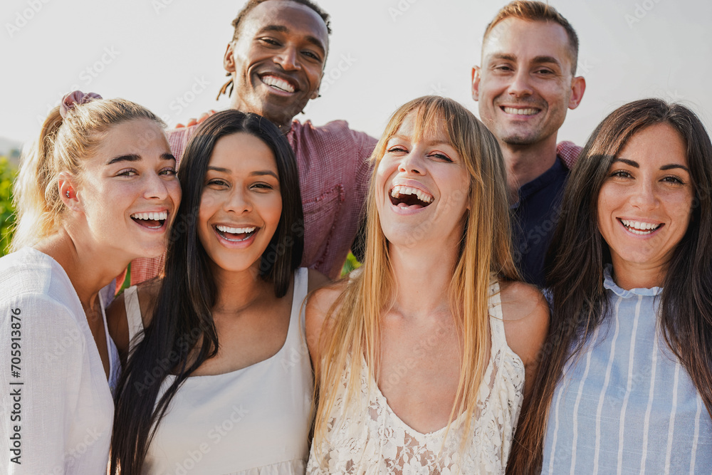 Group of multiracial people smiling on camera during summer time outdoor