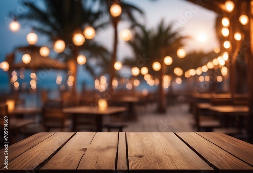 Wooden table and blur beach cafes background with bokeh lights High quality photo