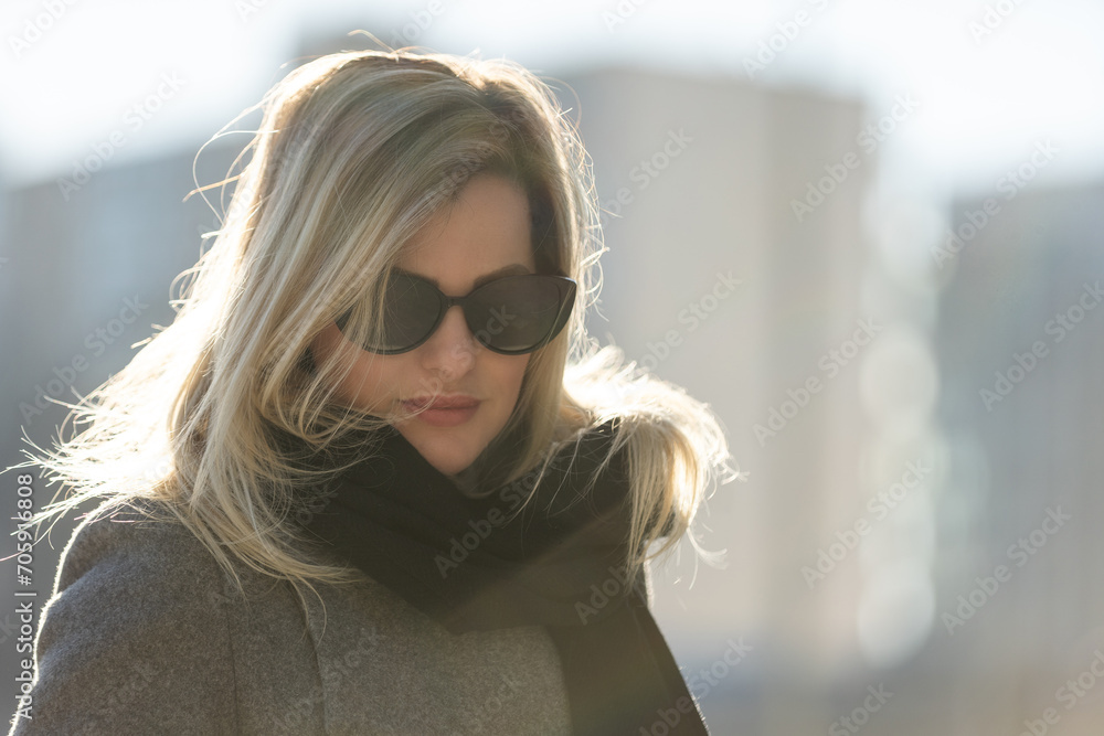 Beautiful girl in a ccoat and scarf and black glasses Beautiful girl in a ccoat and scarf and black glasses