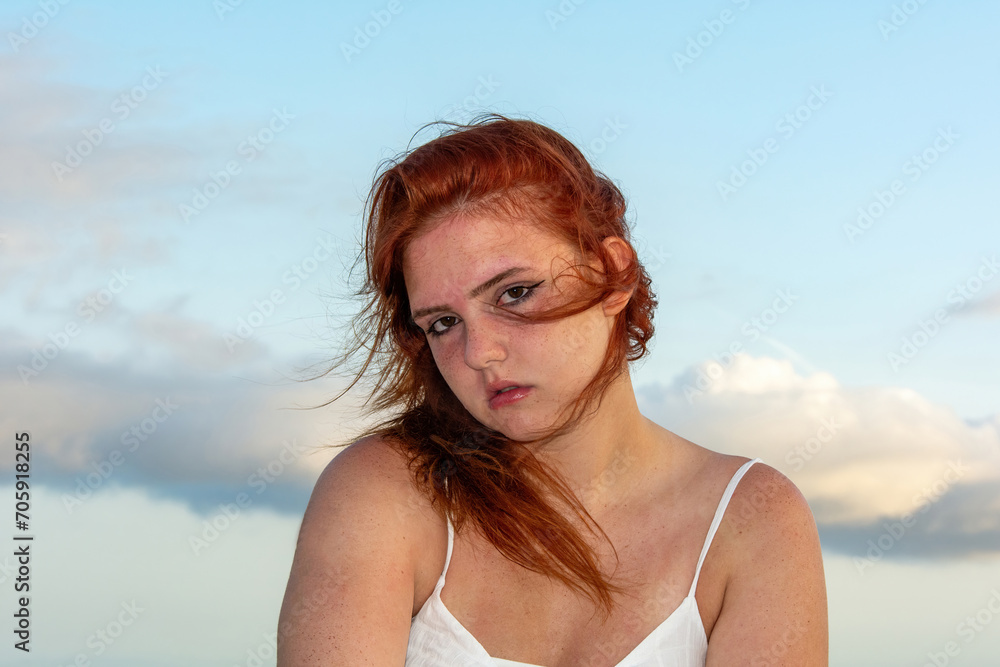 Young woman with windblown hair and sky Young woman with windblown hair and sky