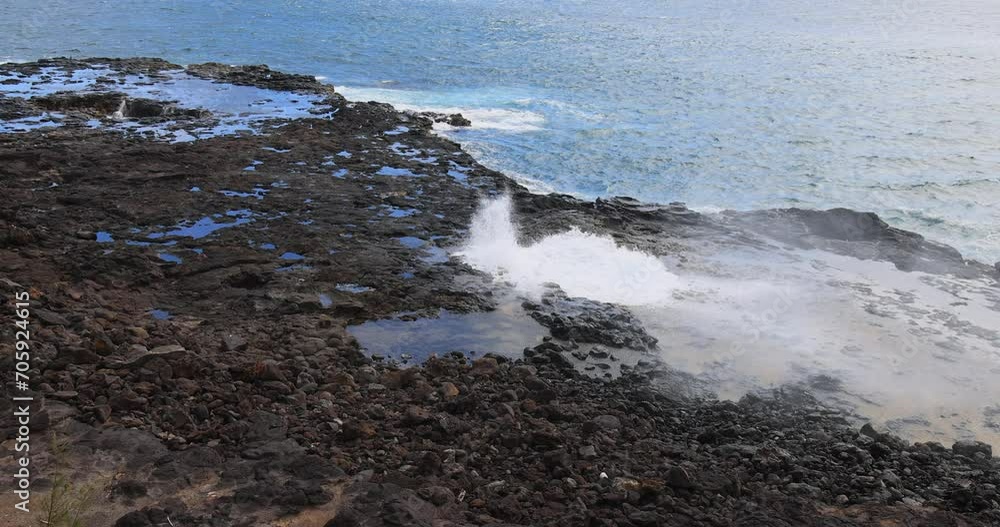 Spouting Horn blow hole coast Kauai Hawaii. Crashing ocean surf waves. Tourist Hawaiian seascape recreation. Garden Isle. Volcanic mountain lava rocky coast geology. Pacific ocean. Spouting Horn blow hole coast Kauai Hawaii. Crashing ocean surf waves. Tourist Hawaiian seascape recreation. Garden Isle. Volcanic mountain lava rocky coast geology. Pacific ocean.