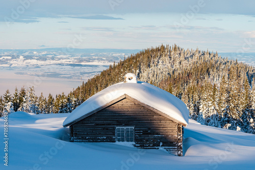 Old protected summer farm farmhouse up in the Totenaasen Hills, Oppland, Norway, in winter.
